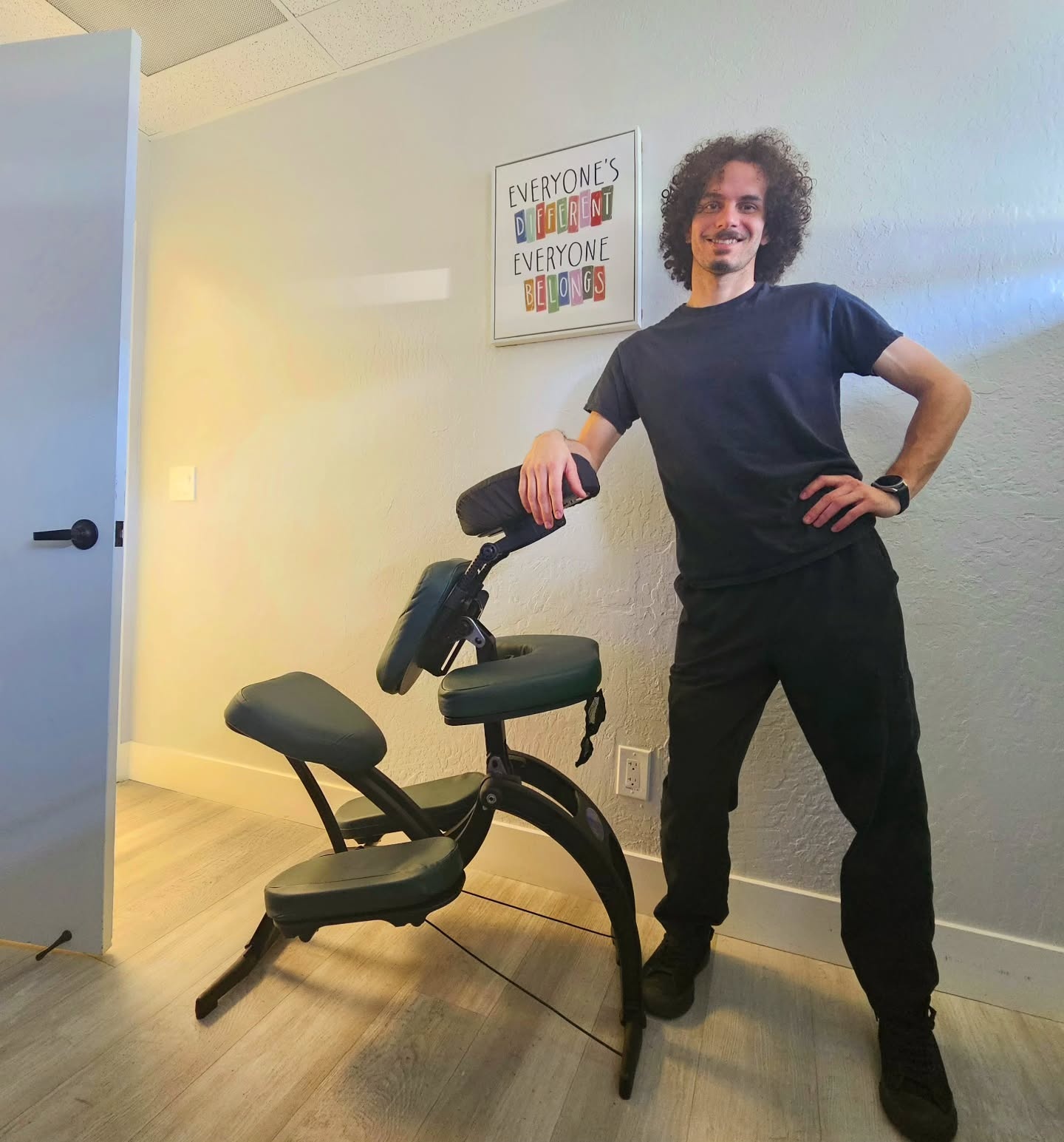 Beto seated, certified neuromuscular massage therapist